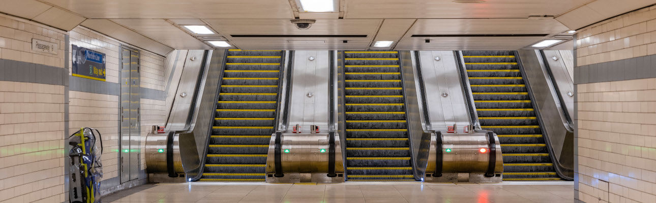 Three escalators at a station. 