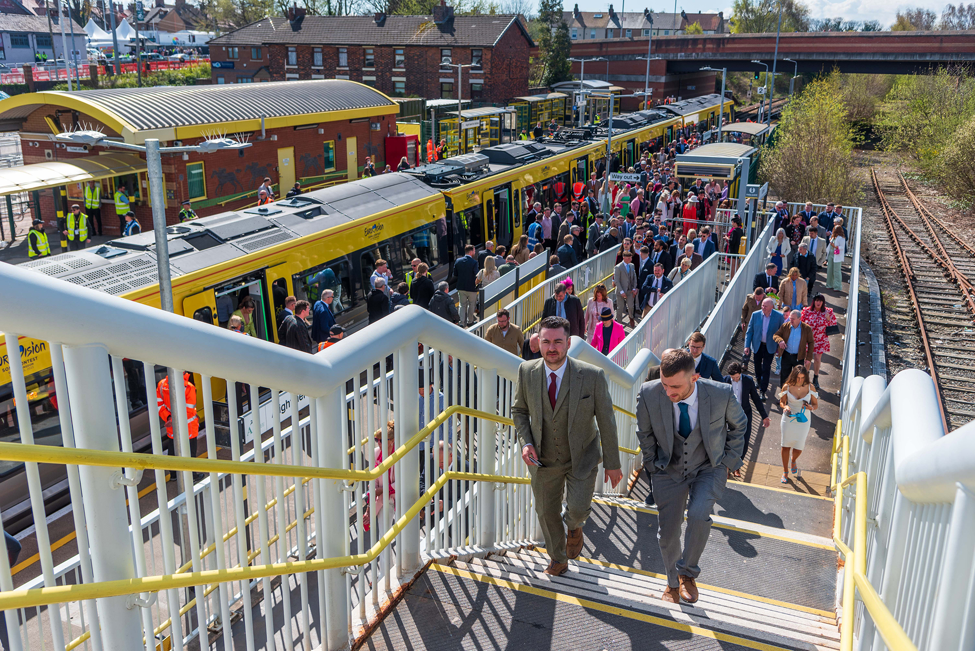 Racegoers leaving Aintree station after departing a train. 