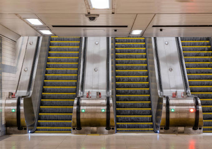 Three empty escalators at an underground station. 